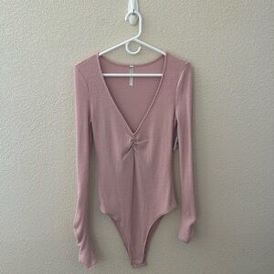 Cute pink woman’s v neck body suit. Long sleeve. Never been worn with tags on.